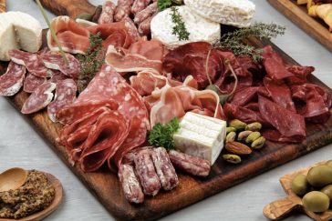 Tábua de frios com queijos, azeitonas e salames ilustrando o artigo sobre como montar tábua de frios e harmonizá-la com vinhos